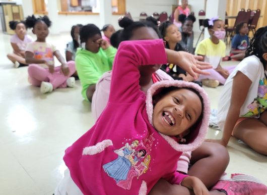 scholar smiles with joy while leaning